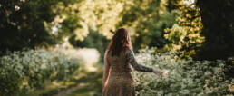 girl touching wild flowers