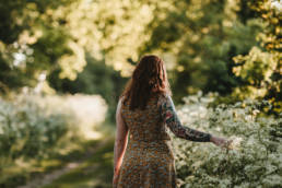 girl touching wild flowers