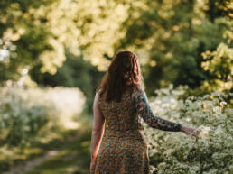 girl touching wild flowers